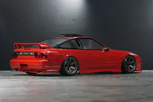 Rear three-quarter view of a red Pandora RC RPS13 180SX Kouki drift body shell on a dark studio background.