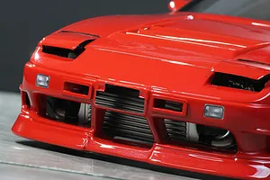 Close-up front view of a red Pandora RC 180SX Kouki body shell showing the front bumper, pop-up headlight housings, and front intercooler.