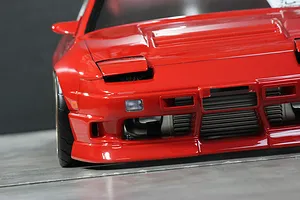 Close-up frontal view of a red Pandora RC RPS13 180SX Kouki drift car body shell showing pop-up headlights and front bumper detail.