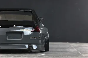 Rear view of a grey Pandora RC Nissan 350Z Fairlady body shell featuring Origin Labo decals and wide fenders.
