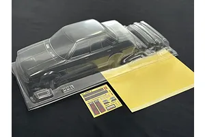 Pandora RC Toyota Corolla KE70 clear unpainted RC body shell with included decal sheet and window masks on a dark surface.