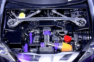 Detailed top-down view of an installed RC scale model engine bay accessory set with custom painted details.