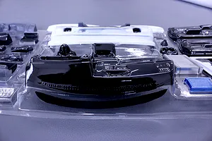 Uncut plastic RC interior parts set including dashboard and accessories in a clear blister pack.