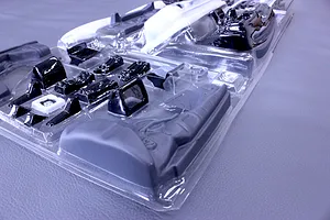 Unopened clear blister pack containing molded plastic interior accessory parts for an RC model car.