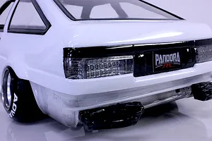 Rear view of a white RC drift car body showing detailed tail lights, black bumper trim, and Pandora RC branding.