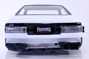 Rear view of an RC car body painted white with black trim and Pandora RC branding on the rear license plate area.