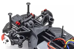 Close-up studio shot of the front suspension and chassis components of the Kyosho Fazer Mk2 RC car against a white background.