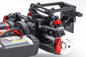 Close-up of the rear suspension, shock absorbers, brake disc, and chassis components of the Kyosho Fazer Mk2 RC car.