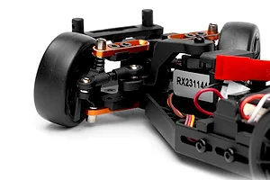 Close-up of the front suspension, steering servo, and chassis components on an HPI RC car.
