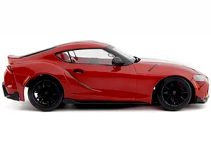 Studio side profile view of the red HPI Stage D24 Toyota Supra GR RC car on a white background.