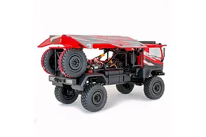 Rear-three-quarter view of the HobbyPlus DKR-4 Fortis 1/18 electric desert rally truck in red, showing the roll cage, spare tires, and chassis layout.