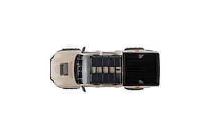 Top down view of the brown Axial Toyota Tacoma RC rock crawler truck on a white background, showcasing its roof rack and truck bed.