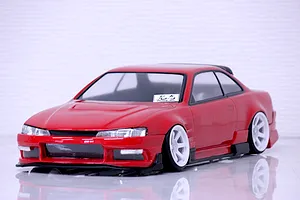 Red RC drift car body shell styled after the S14 Silvia late model with white wheels on a reflective white background.
