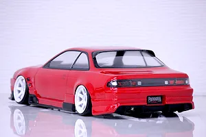 Rear-three-quarter view of a painted red S14 Silvia RC drift car body shell on white background.