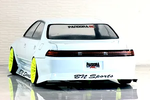 Rear three-quarter view of a white RC drift car body shell with bright yellow wheels and BN Sports branding.