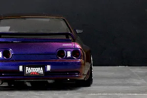 Rear view of a painted Pandora RC BNR32 Skyline GT-R drift body shell in metallic purple, featuring detailed taillights and a Pandora RC license plate.