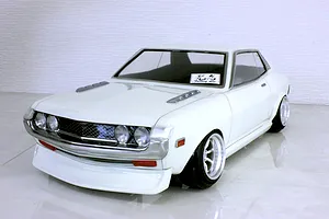 A painted white Pandora RC Toyota Celica 1600GT body shell mounted on an RC chassis against a white background.