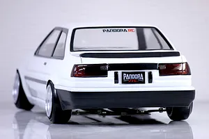 Rear view of Pandora RC Toyota AE86 Sprinter Trueno 2-door white drift RC body shell mounted on a chassis.