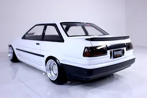 Rear three-quarter view of a painted white RC drift car body shell mounted on a chassis against a plain white background.