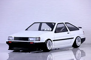 A painted white and black Pandora RC Toyota AE86 Corolla Levin 3-door body shell mounted on an RC chassis with deep-dish wheels.