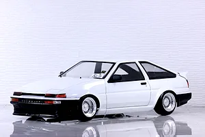 Painted white Toyota AE86 Sprinter Trueno RC drift car body mounted on a chassis with custom mesh wheels.