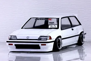A painted white Pandora RC Honda Civic Si RC drift car body shell mounted on a chassis with custom wheels against a white brick background.