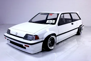 A painted white Honda Civic RC drift car body mounted on a chassis with black wheels against a white studio background.