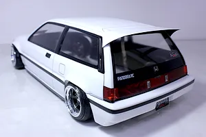 Rear three-quarter view of a white RC car body shell resembling a classic Honda Civic hatchback with custom wheels and decals.