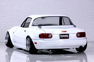 Rear three-quarter view of a white Pandora RC Mazda Eunos Roadster NA drift car body shell on a glossy surface.