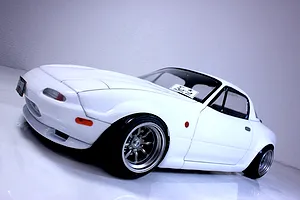 Painted white RC drift car body shell modelled after a Mazda Eunos Roadster NA on a white background.