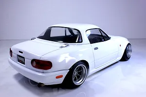 Rear high-angle studio shot of a white Pandora RC Mazda Eunos Roadster NA drift car body shell mounted on a chassis.