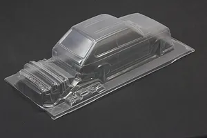 Unpainted clear polycarbonate RC car body shell for Toyota Starlet KP61 on a dark surface.