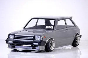 A grey Pandora RC Toyota Starlet KP61 late model body shell mounted on an RC chassis with custom wheels against a white background.