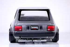 Rear view of a painted grey Toyota Starlet KP61 RC body shell with Pandora RC license plate against a white background.