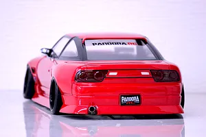 Rear view of a red RC drift car body shell showing stance, exhaust tip, and Pandora RC branding on a light background.