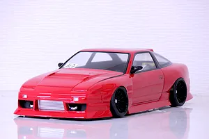Front three-quarter view of a red Pandora RC 180SX drift car body shell mounted on a chassis with black multi-spoke wheels.