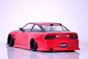 Rear three-quarter view of a painted red RC drift car body featuring black wheels, tinted windows, and a Pandora RC license plate.