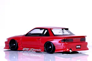 Rear-three-quarter profile of a red Pandora RC S13 Silvia drift car body featuring BN Sports decals and black multi-spoke wheels on a reflective white surface.