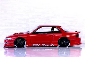 Side profile of a red S13 Silvia RC drift car body shell with BN Sports graphics mounted on a chassis.