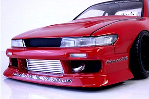 Close-up front angle of a red Pandora RC S13 Silvia drift car body shell featuring BN Sports styling, front intercooler, and decal details.