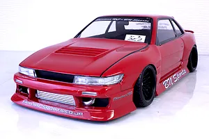Red Pandora RC S13 Silvia BN Sports drift body shell mounted on an RC chassis with custom wide body kit and black wheels.