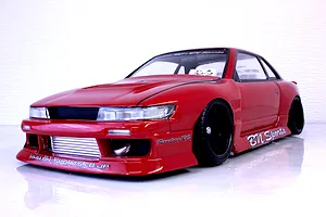 A painted red Pandora RC S13 Silvia drift body shell with BN Sports decals mounted on a chassis with black wheels.
