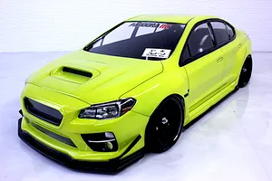 Bright neon green painted RC drift car body shell mounted on a chassis with black wheels against a white background.