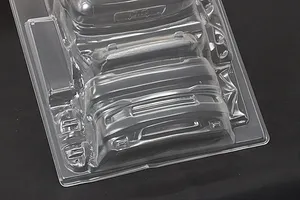 Unpainted clear polycarbonate RC car body accessories and bumper parts on a black background.