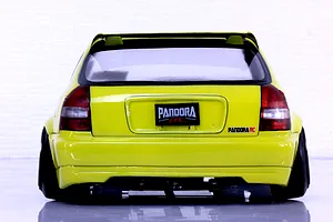 Rear view of a yellow Honda Civic EK9 RC body shell by Pandora RC showcasing the spoiler and decals on a white background.
