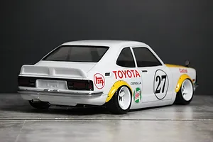 Rear three-quarter view of a painted Toyota Corolla Levin TE27 RC body shell in white with racing decals and white wheels.