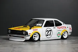 A painted Pandora RC Toyota Corolla Levin TE27 body shell with white and yellow racing livery, mounted on a chassis.
