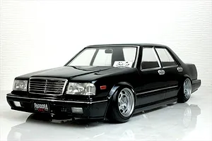 A painted black Pandora RC Y31 Cedric sedan drift body shell mounted on an RC chassis against a white background.