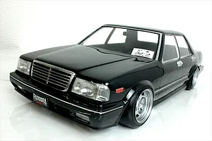 Front three-quarter view of a black Y31 Cedric sedan RC body shell by Pandora RC on a white surface.