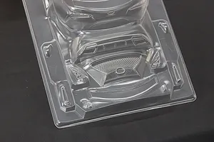 Unpainted clear polycarbonate RC car body accessories and parts molded on a single sheet against a dark background.